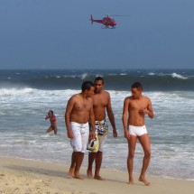Handsome guys with helicopter looking for surfers in distress